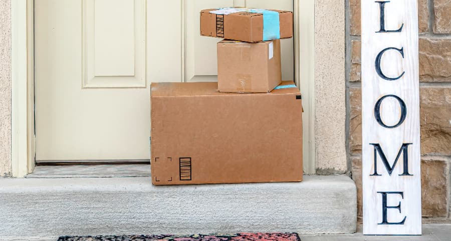 Packages on the doorstep of a home with a welcome sign in Alpharetta